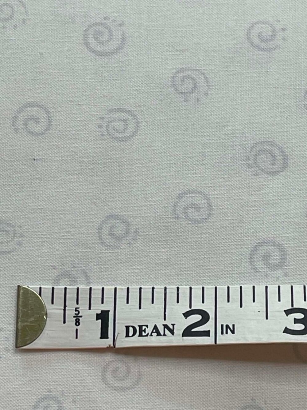 Gray Swirls on white fabric.  Sold by the yard.